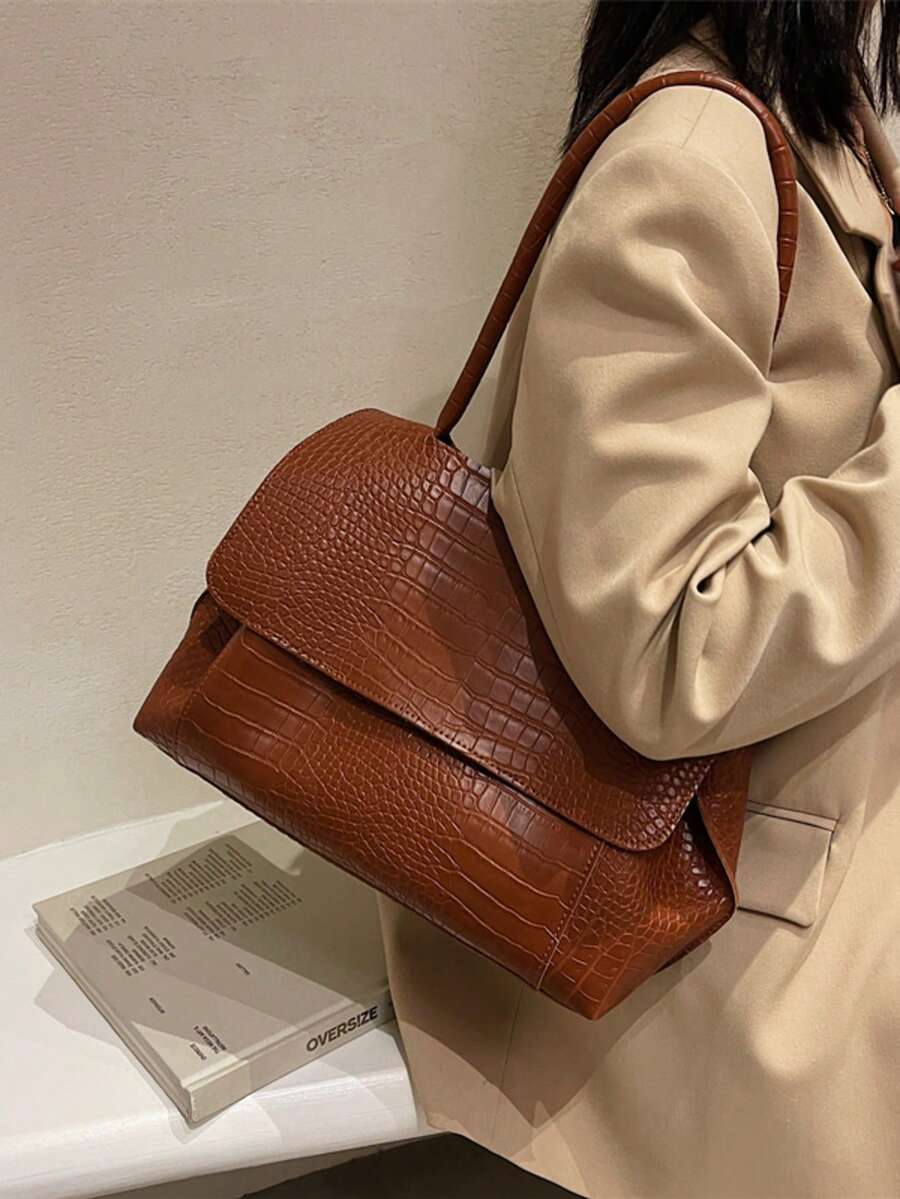 Varelle Croc-Embossed Satchel in brown, worn on the shoulder