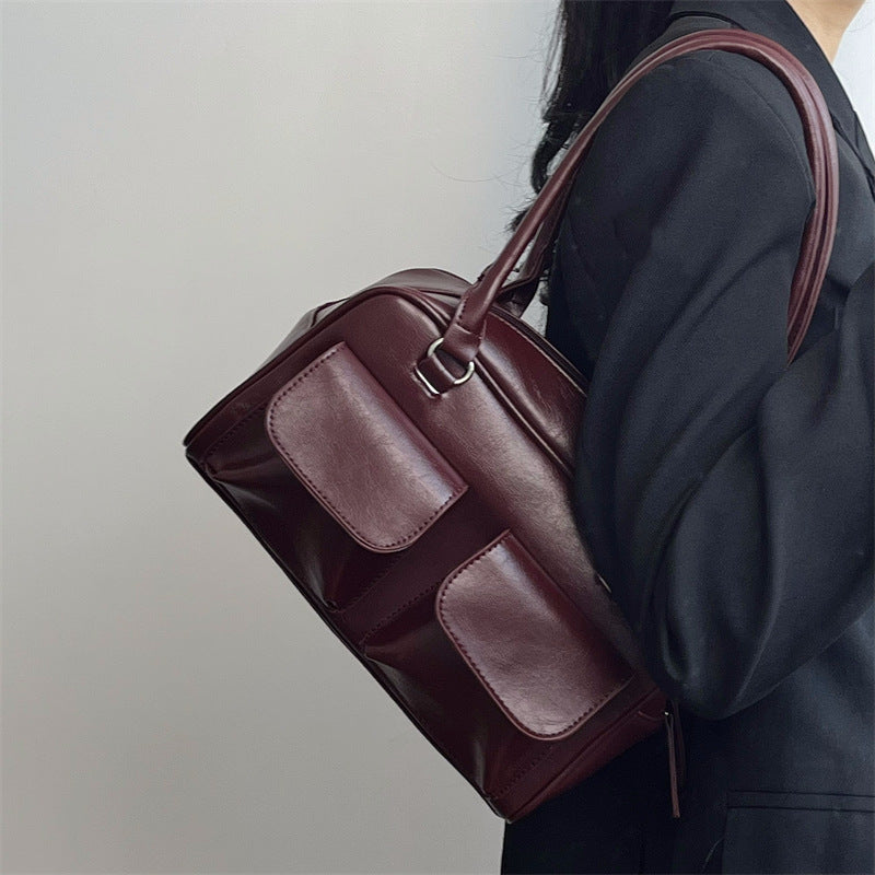 Romy Glossy Pocket Bag in wine red, worn on the shoulder