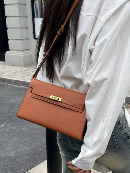 Élise Envelope Shoulder Bag in golden brown, worn on the shoulder