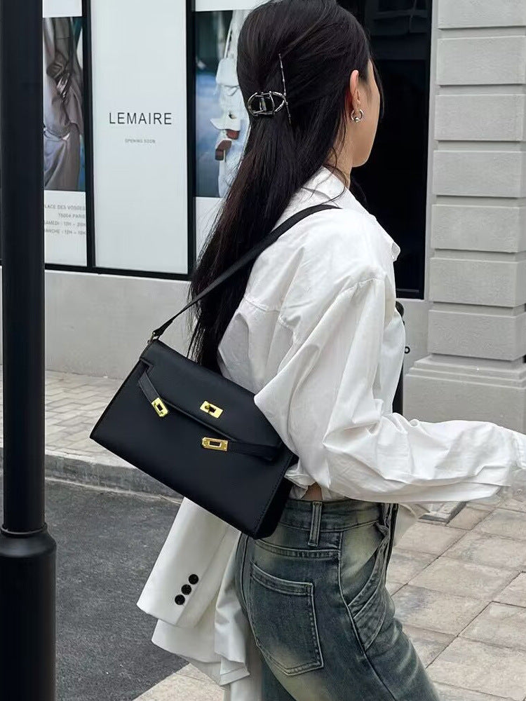 Élise Envelope Shoulder Bag in black, worn on the shoulder