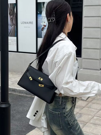 Élise Envelope Shoulder Bag in black, worn on the shoulder