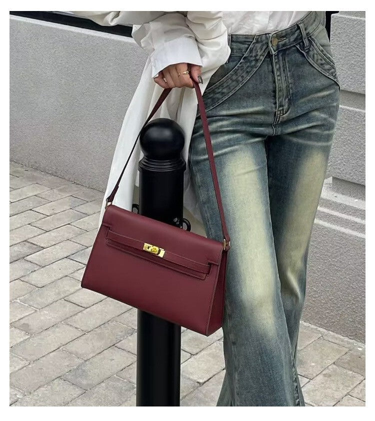 Élise Envelope Shoulder Bag in Bordeaux red, worn by a model